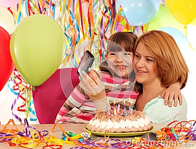 Mom and daughter take pictures at a birthday