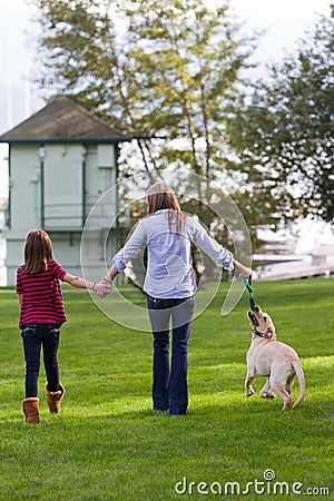 Mom And daughter walking the dog