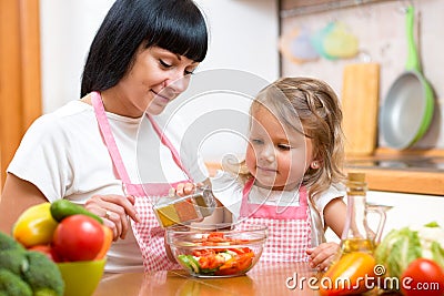 Mom and kid girl preparing healthy food