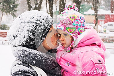 Mom kissing baby