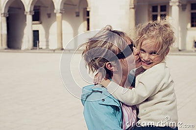 Mom kissing her daughter