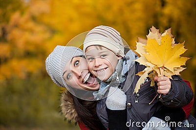 Mom and son on a yellow autumn park background