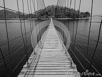 Monchrome rope bridge direct to lonely island across the lake