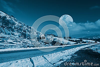 Moon in the sky on snowy mountain
