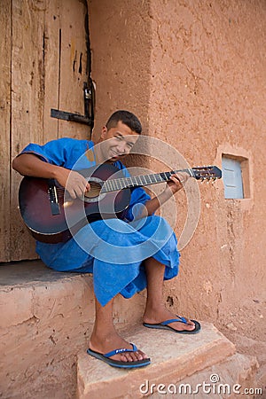 Moroccan man musician playing guitar, Morocco