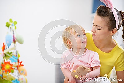 Mother and baby eating Easter rabbit cookie