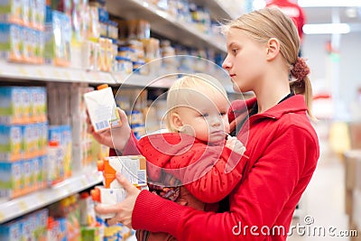 Mother with baby shopping in supermarket