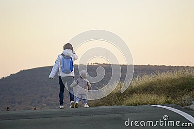 Mother and child walking away