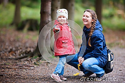 Mother and daughter at autumn park