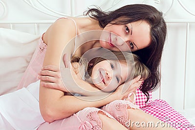 Mother and daughter on bed