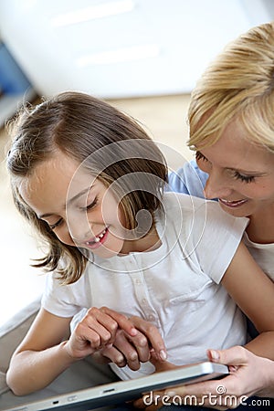 Mom with little girl using tablet