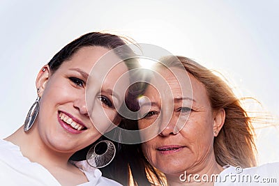 Mother and daughter posing in the summer sun