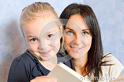 Mother and daughter are reading a book