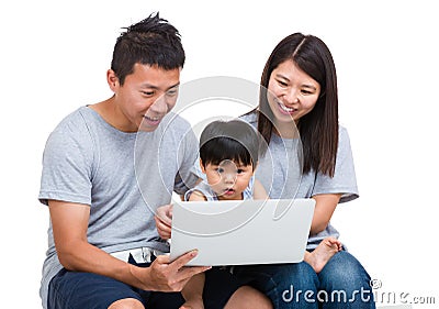 Mother, father and baby son looking at laptop computer