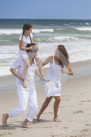 Mother, Father & Child Family Playing At Beach