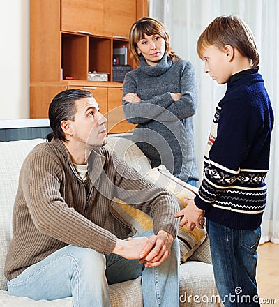 Mother and father together scolding son