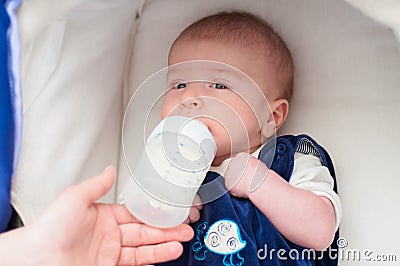 Mother feeding her baby from a bottle