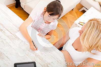 Mother helping her daughter with the homework