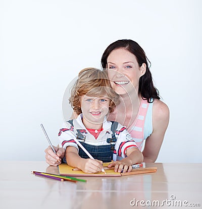 Mother helping her son to draw