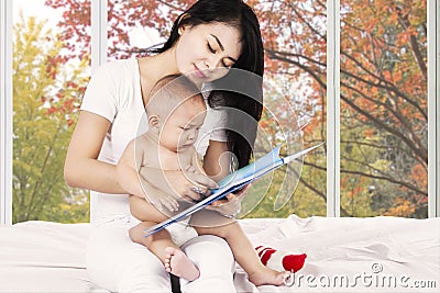 Mother and her baby read story book
