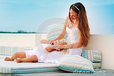 Mother and her daughter relax in sea background