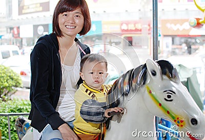 Mother and her son horse riding