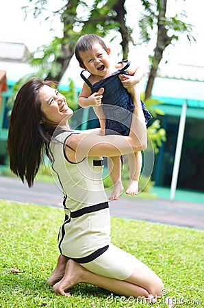 Mother holding baby happy face