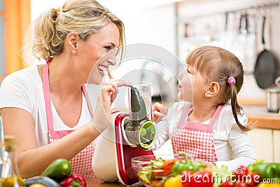 Mother and kid girl preparing healthy food