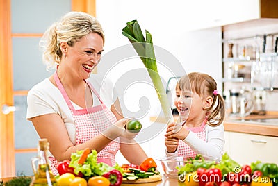 Mother and kid preparing food and having fun
