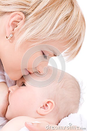 Mother kiss and breast feeding her baby girl