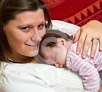 Mother kissing baby asleep