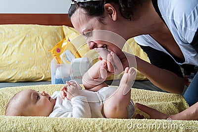 Mother kissing baby feet