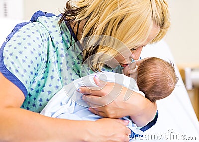 Mother Kissing Newborn Babygirl In Hospital