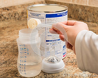 Mother preparing baby formula