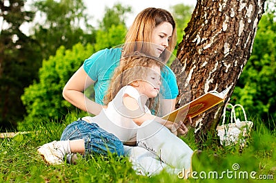 Mother reading book to her daughter