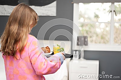 Mother s day, a daughter carries a tray of breakfast to her mum