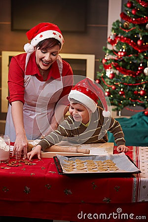 Mother and son making christmas cake