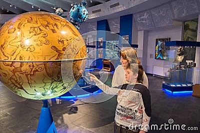 Mother and son in museum of the Moscow Planetarium, Russia