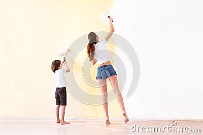 Mother and son paiting walls in a new house