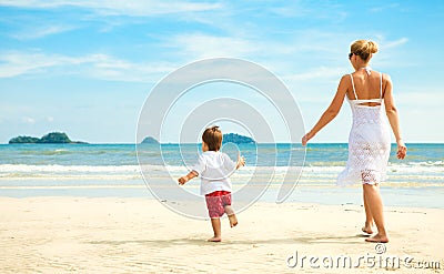 Mother and son running on beach