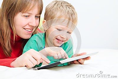 Mother and son with touch pad at home