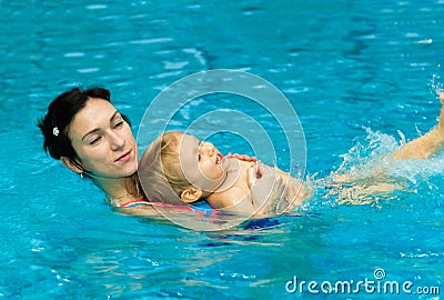 Mother teaching baby boy to swim