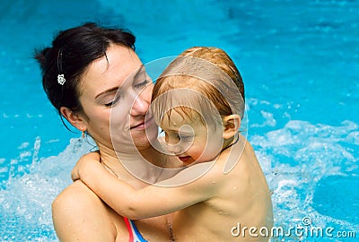 Mother teaching baby boy to swim