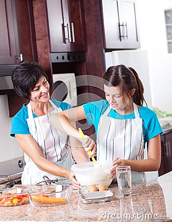 Mother teaching daughter baking