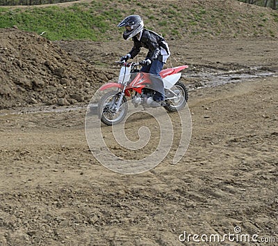 Motocross Racer Riding on a Dirt Track