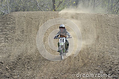 Motocross Racer Riding Down a Dirt Hill