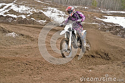 Motocross rider on a motorcycle rides cornering