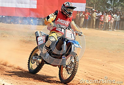 A motocross rider speeding into a turn