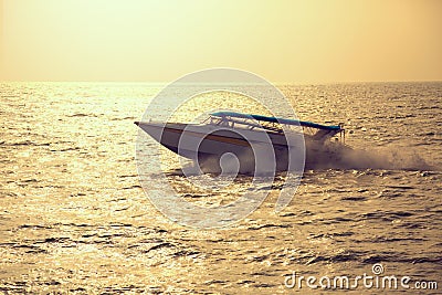 Motor boat on sunset