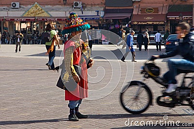 A motorbiker avoids a motionless water seller